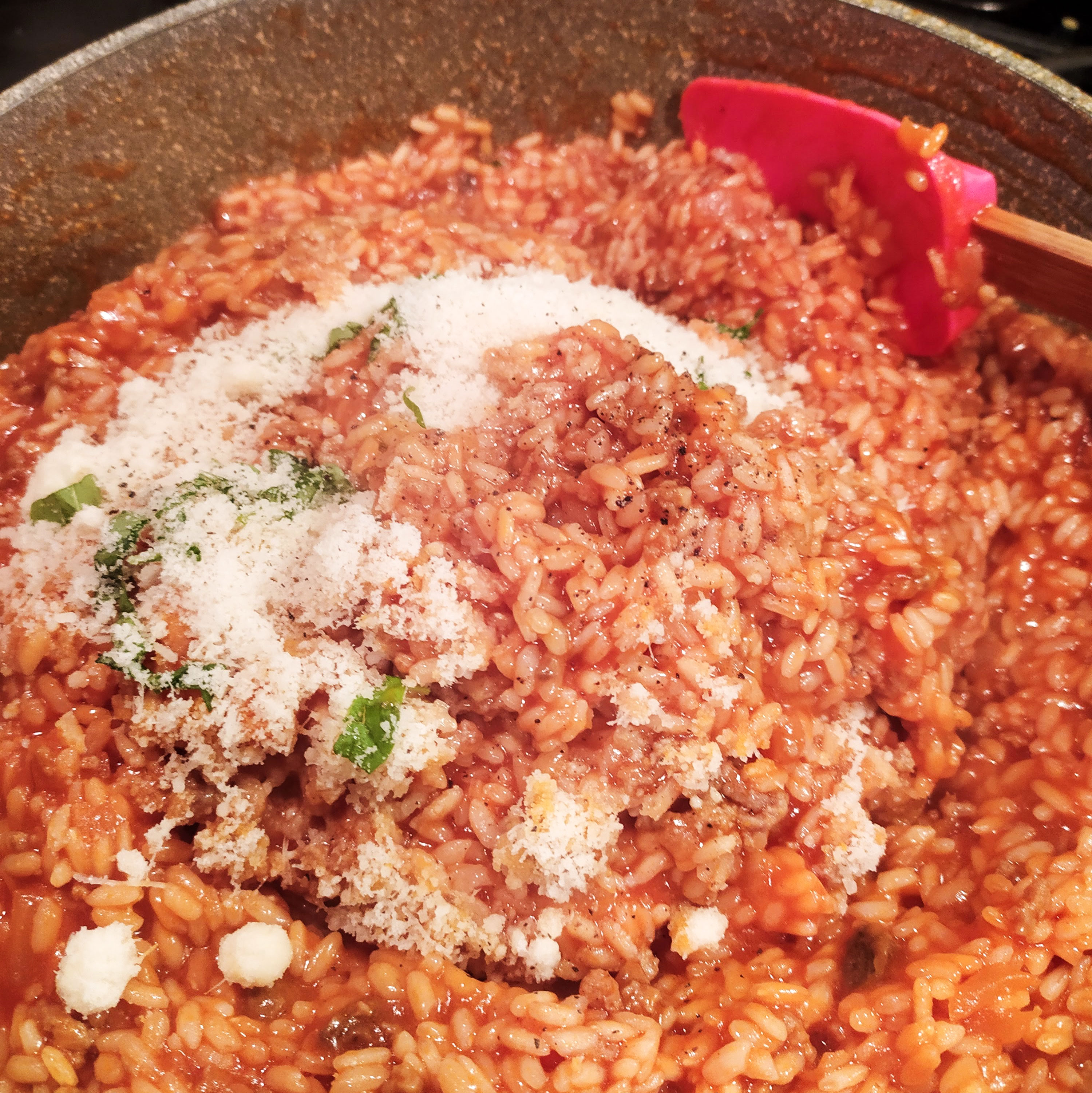 rice for suppli while is cooking in bolognese sauce